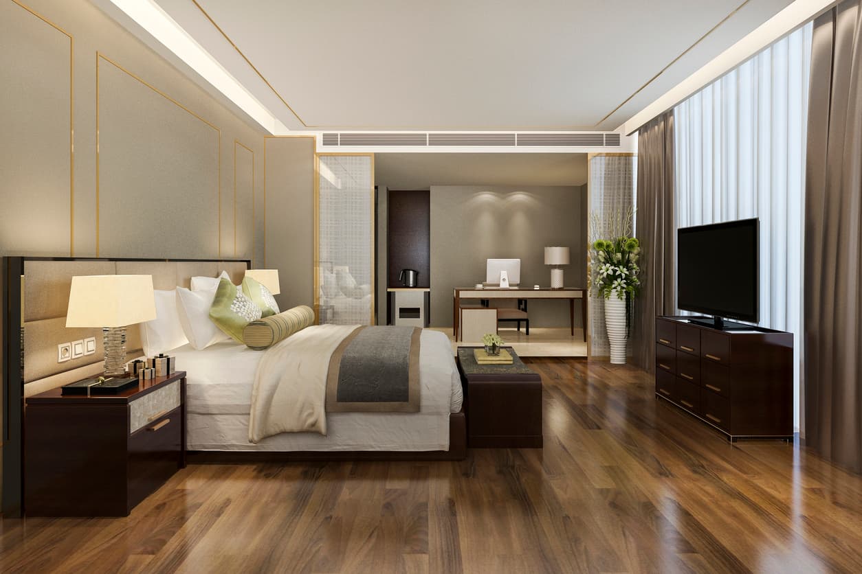 Modern luxury hotel suite bedroom set with upholstered bed and lounge seating