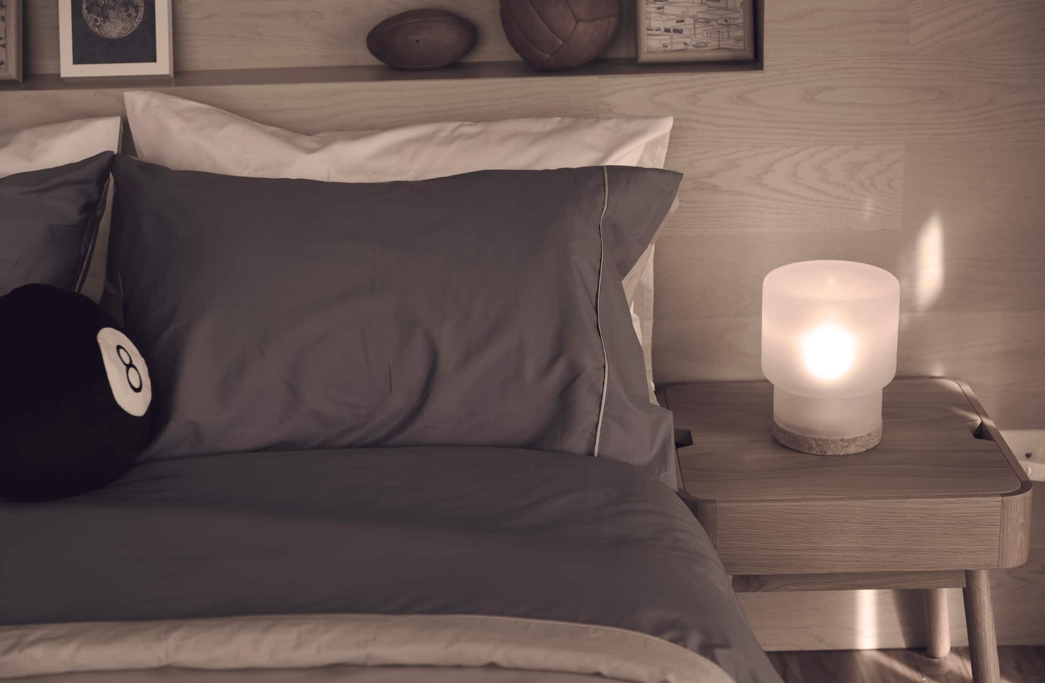 Hotel nightstand manufacturer in Turkey presenting wooden bedside table with integrated shelf and ambient lighting.