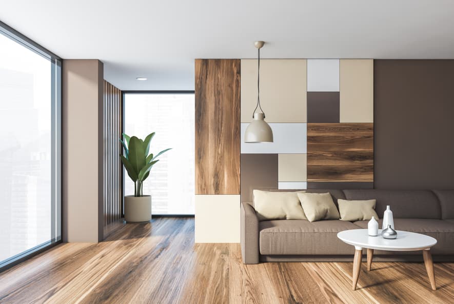 Spacious hotel suite with white sofa, patterned carpet, and separate bedroom area