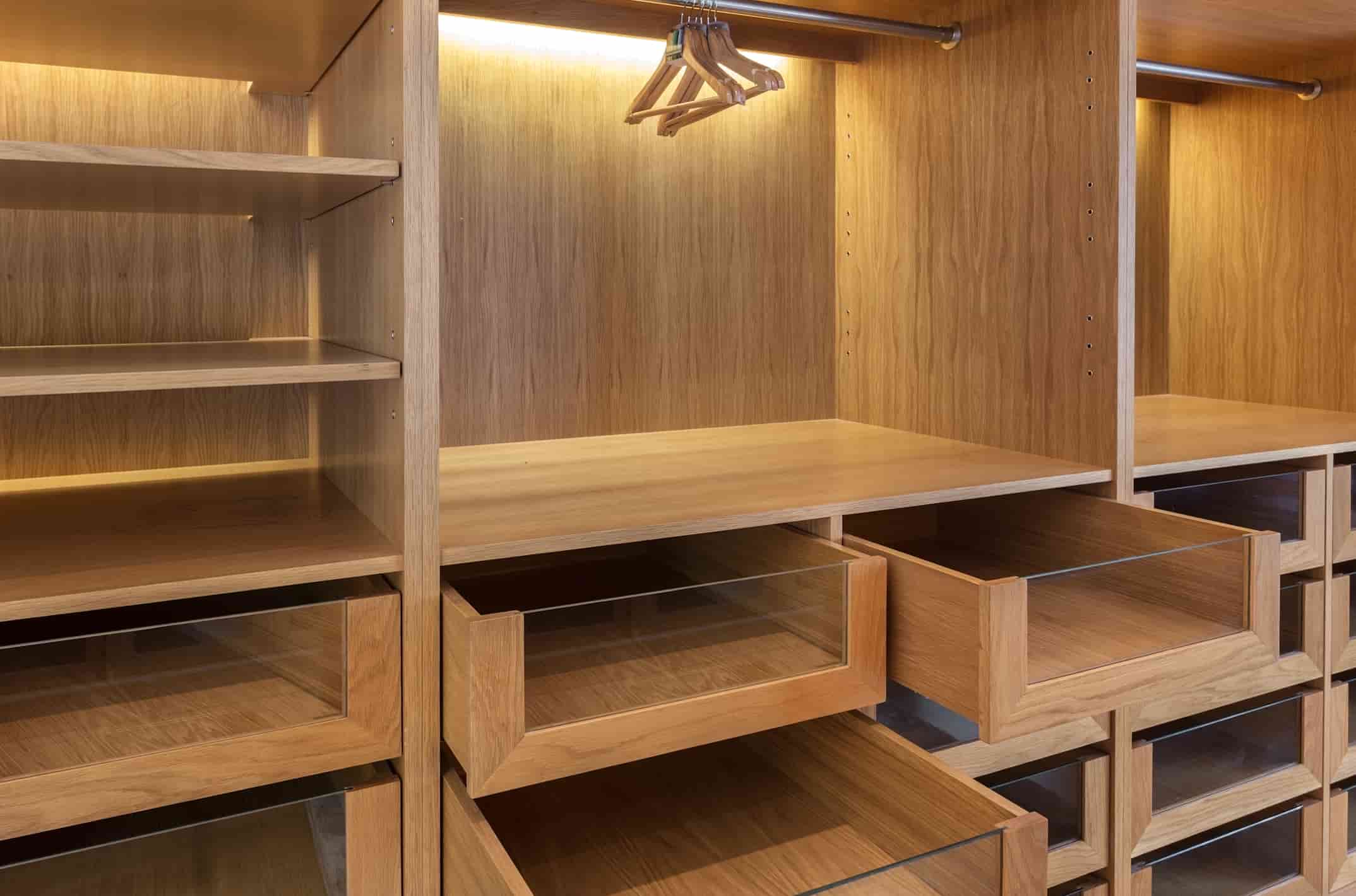 Hotel wardrobe manufacturer in Turkey presenting a custom wooden hotel wardrobe with shelves, drawers, and hanging rails.