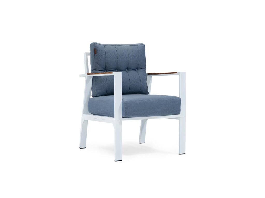 Contemporary lounge chair with blue upholstered cushions, white metal frame, and wooden armrests.