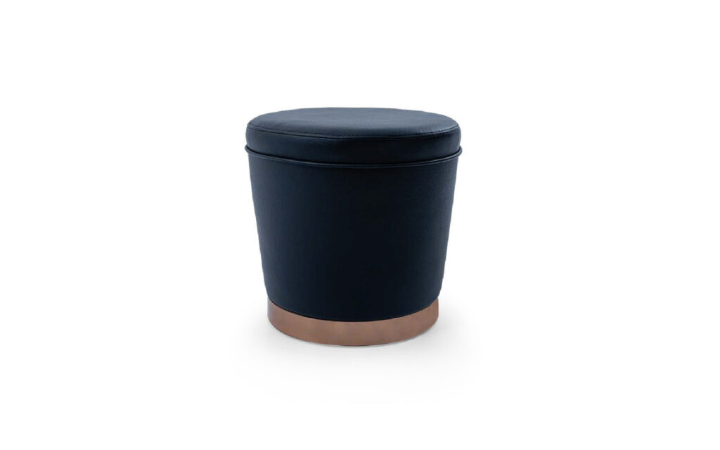 Modern upholstered ottoman pouf with metal base, designed for hotel lobbies, lounges, and commercial seating projects.