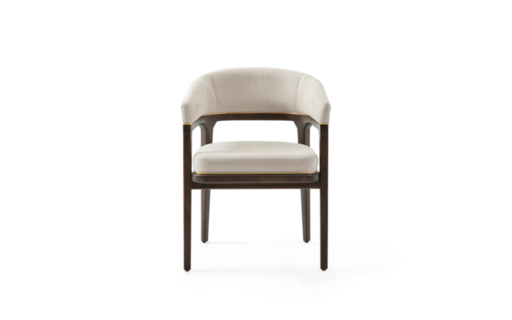 Upholstered restaurant armchair with wooden frame and brass details for café and hospitality seating